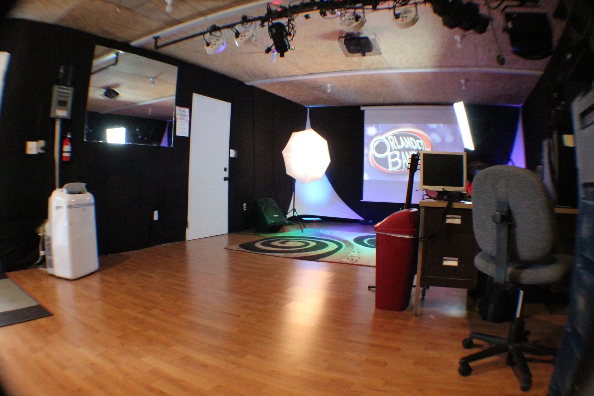 Inside the CFAV rehearsal studio, looking across the floor to the stage