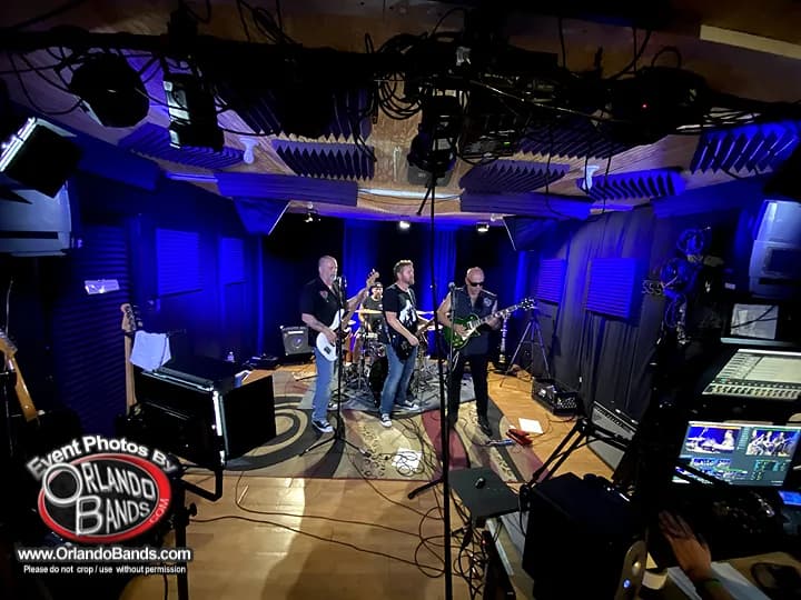 A band rehearsing under stage lighting at the CFAV studio